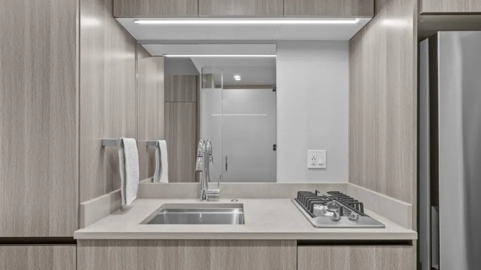 Furnished studio apartment at Salt Lake Crossing with sink and stove.