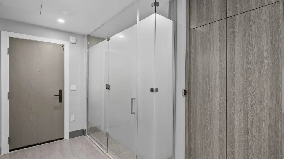 Furnished studio apartment at Salt Lake Crossing with glass wall shower.