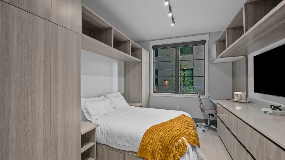 Furnished studio apartment at Salt Lake Crossing with built in shelving and desk.