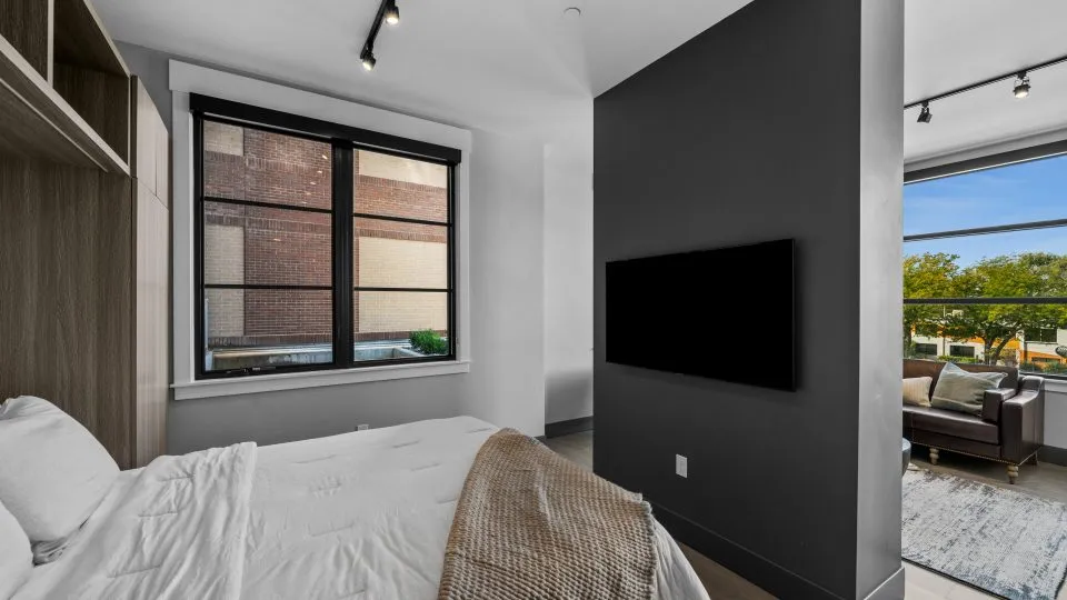 Open one bedroom apartment at Salt Lake Crossing with large windows and living area.