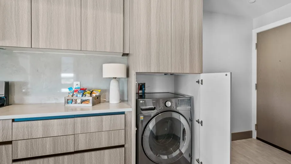 Open one bedroom apartment at Salt Lake Crossing with laundry cabinet.