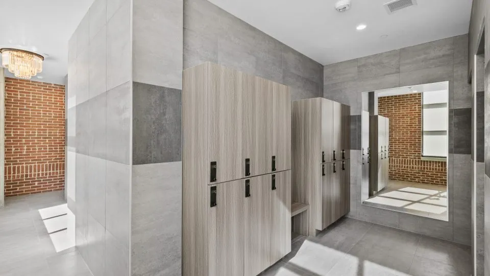 Salt Lake Crossing locker room with lockers and large mirror.