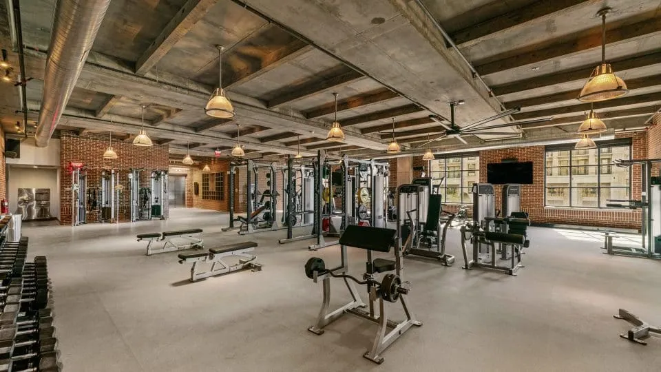 Salt Lake Crossing fitness center with weight equipment and large windows.