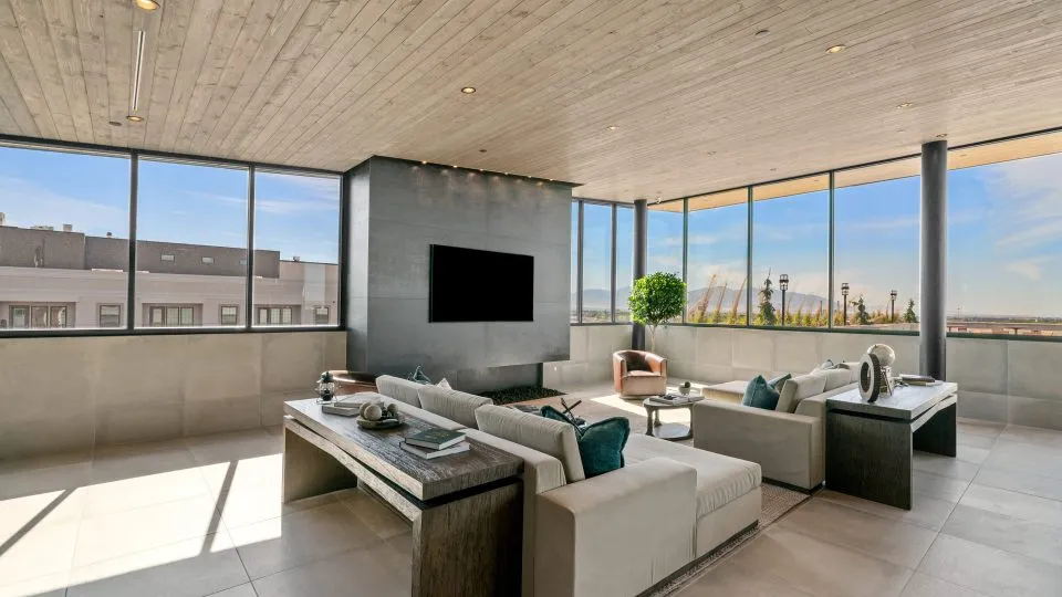 Salt Lake Crossing lounge with plush seating, wall mounted TV and panoramic views.