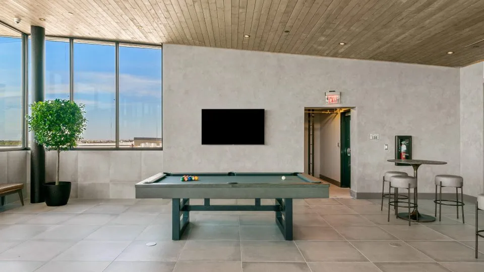 Salt Lake Crossing lounge with billiards table and large windows.