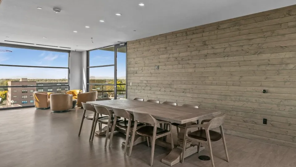 Salt Lake Crossing family room with plush seating and community dining table.