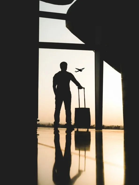 Traveler with suitcase waiting for their flight at Salt Lake City International Airport.