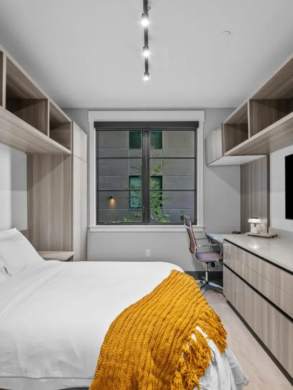 Fully-furnished studio apartment with bed and desk at Salt Lake Crossing.
