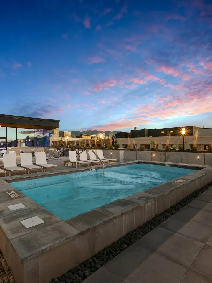 Rooftop pool deck at Salt Lake Crossing at dusk.